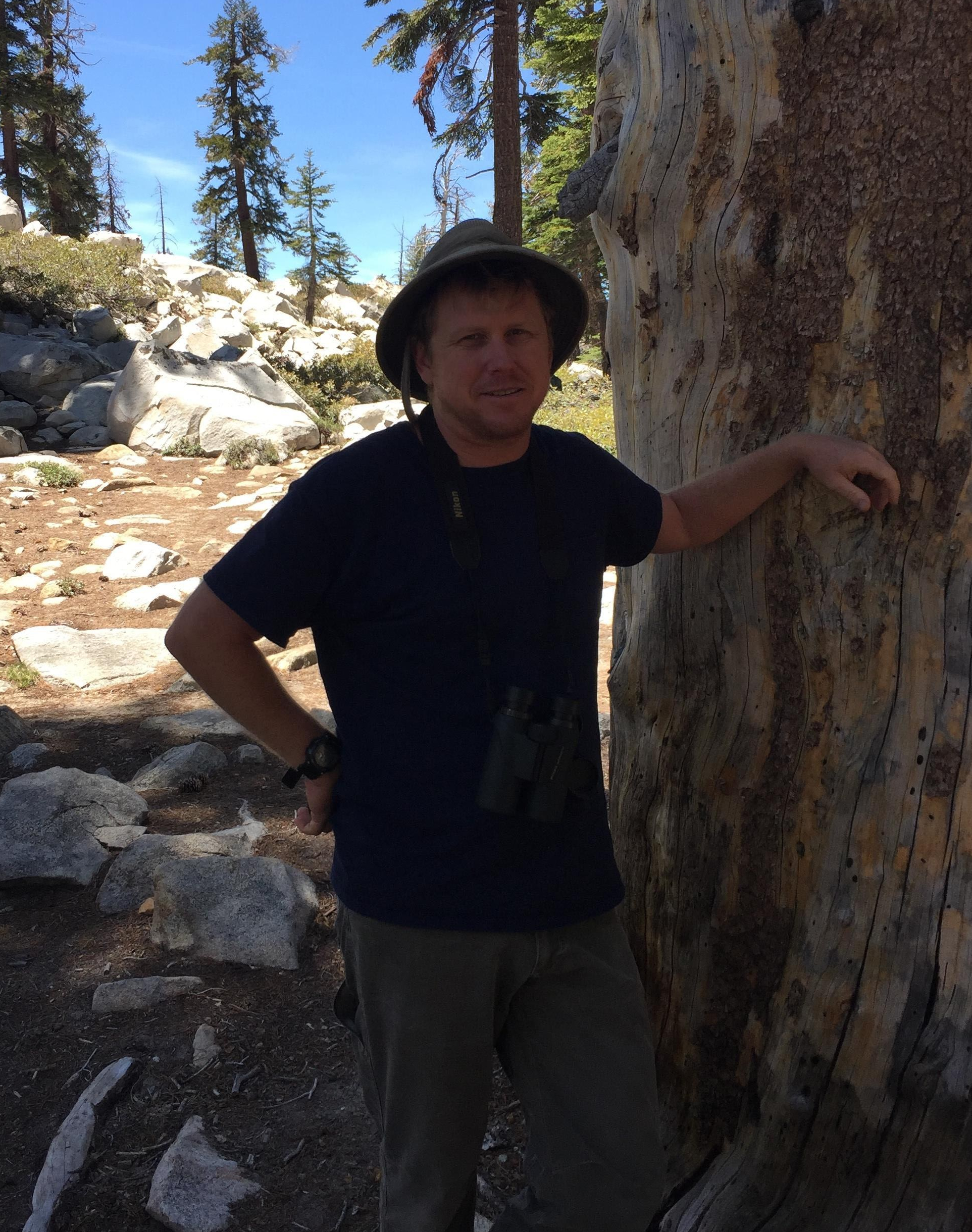 Image of Steven Lee with a dead tree